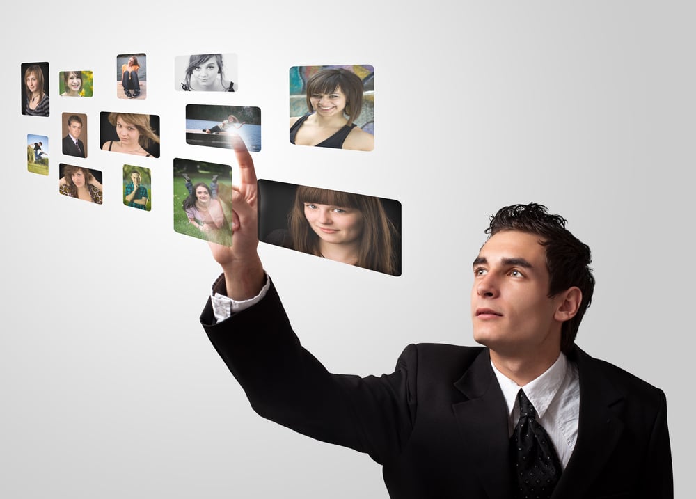 Business man choosing photos from digital gallery