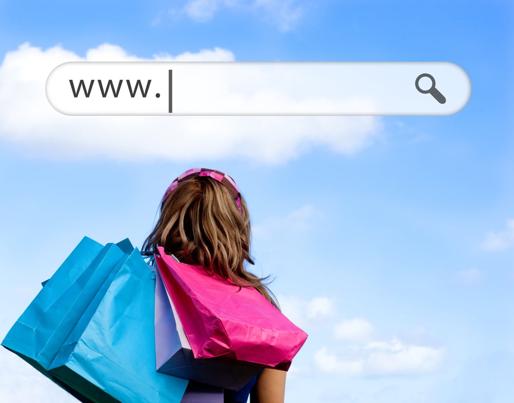 Girl holding shopping bags with address bar above against a blue sky-1